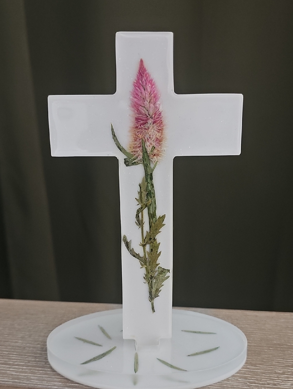 Hand Crafted White Cross with Pink Bloom and Green Foliage